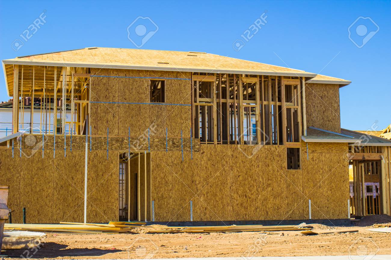 wooden framing plywood on new home under construction stock photo