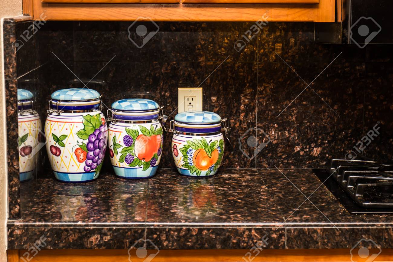 Three Ceramic Kitchen Canisters On Granite Counter Stock Photo
