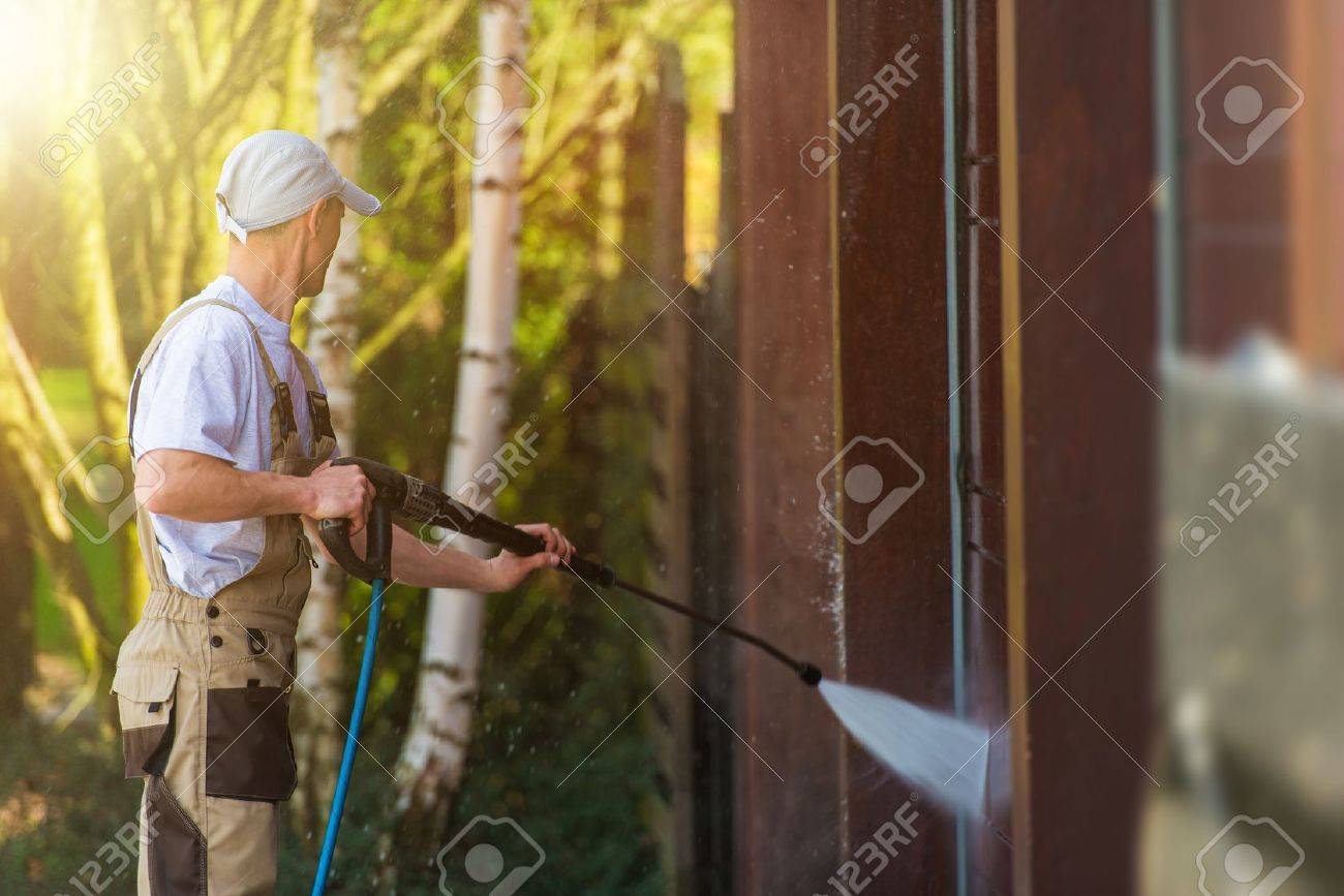 Garage Gate Water Cleaning. Garage Walls and Gate Powerful high Pressure Water Washing. Caucasian Worker Cleaning Building Elements. - 56892247 Garage Gate Water Cleaning. Garage Walls and Gate Powerful high Pressure Water Washing. Caucasian Worker Cleaning Building Elements. - 56892247