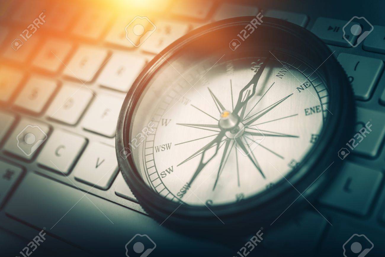 The Internet Navigator Concept Photo. Vintage Metallic Compass on the Computer Keyboard. Navigation Through the Internet. - 56892326 The Internet Navigator Concept Photo. Vintage Metallic Compass on the Computer Keyboard. Navigation Through the Internet. - 56892326