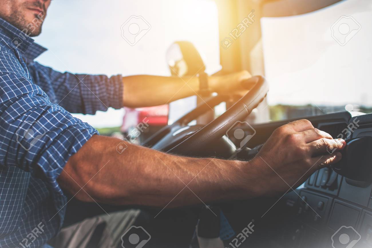 Semi Truck Driver Job. Caucasian Trucker Preparing For Long Haul Shipping. - 92682883 Semi Truck Driver Job. Caucasian Trucker Preparing For Long Haul Shipping. - 92682883