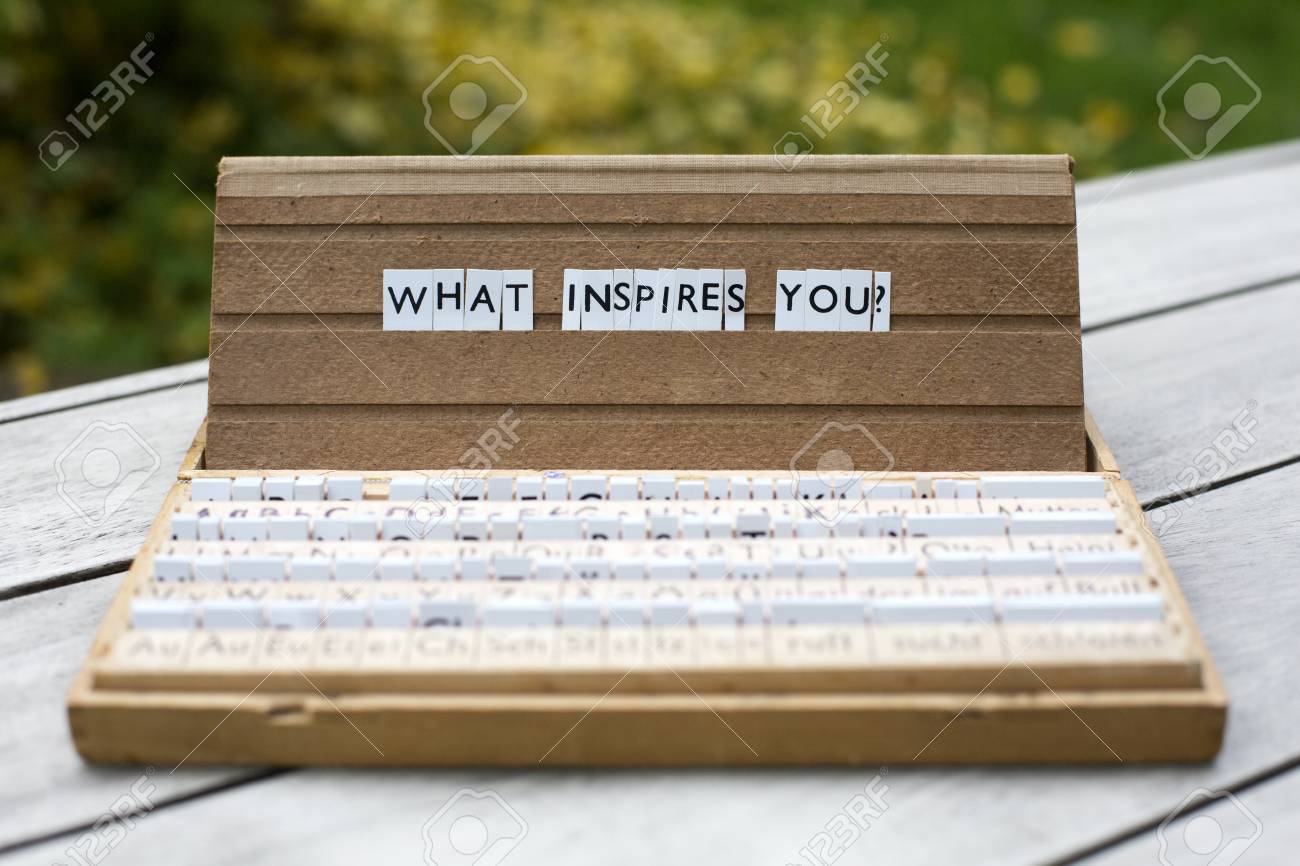 the words what inspires you on an old school letter box stock