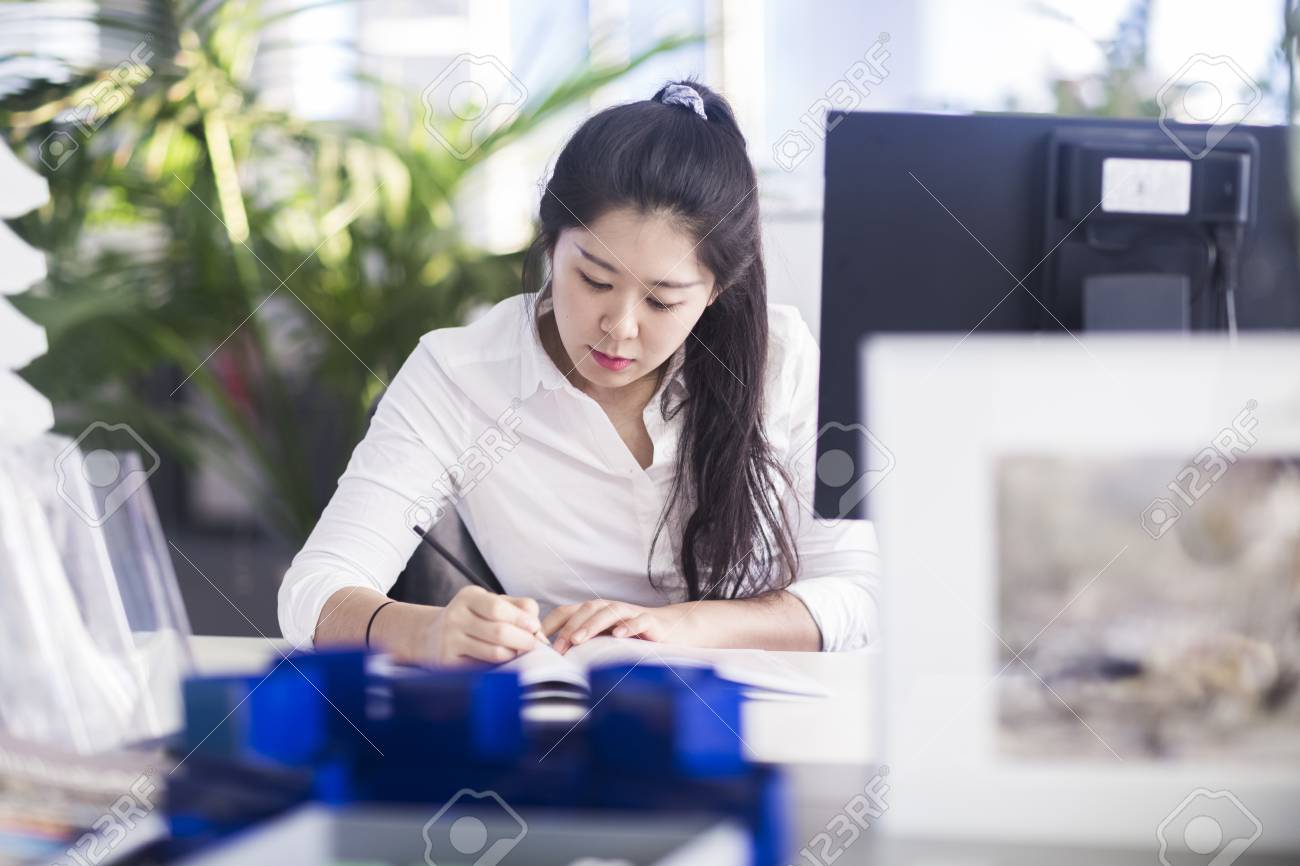 chinese office worker working in corporate business stock photo