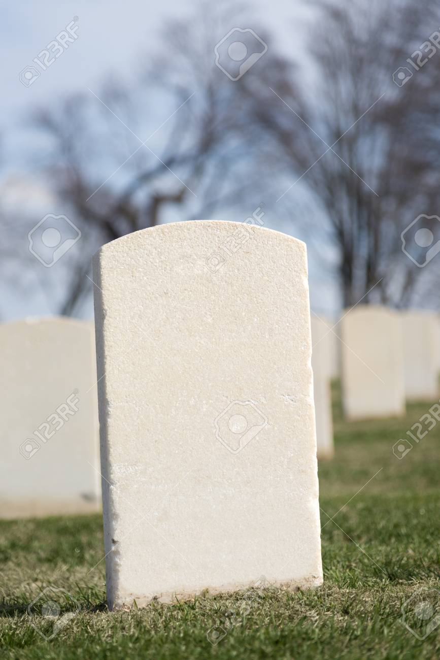 a blank tombstone in a cemetery lots of copy space stock photo