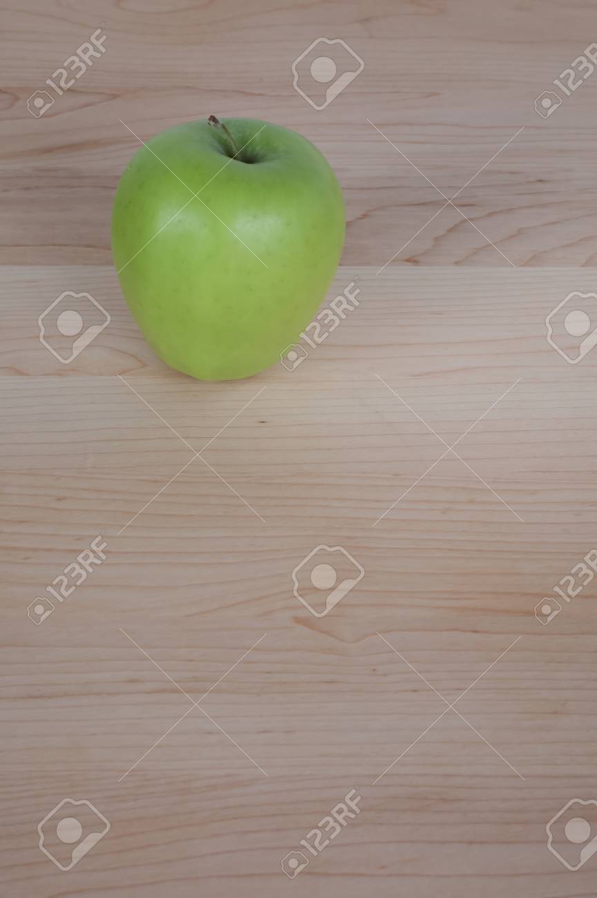Green Apple on Desk or Cutting Board - 17083328 Green Apple on Desk or Cutting Board - 17083328
