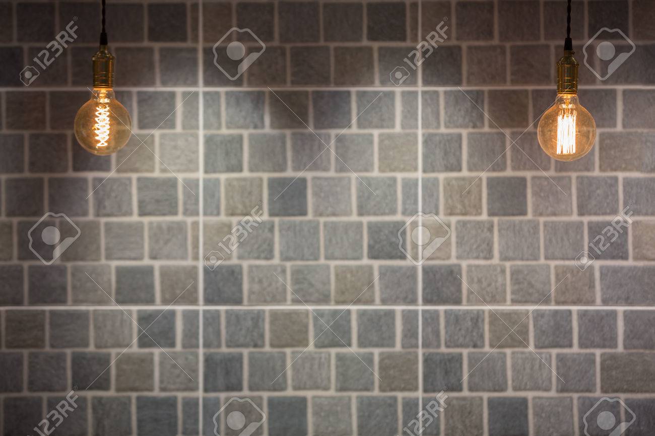 Industrial and vintage style lighting bulbs with stone tiles