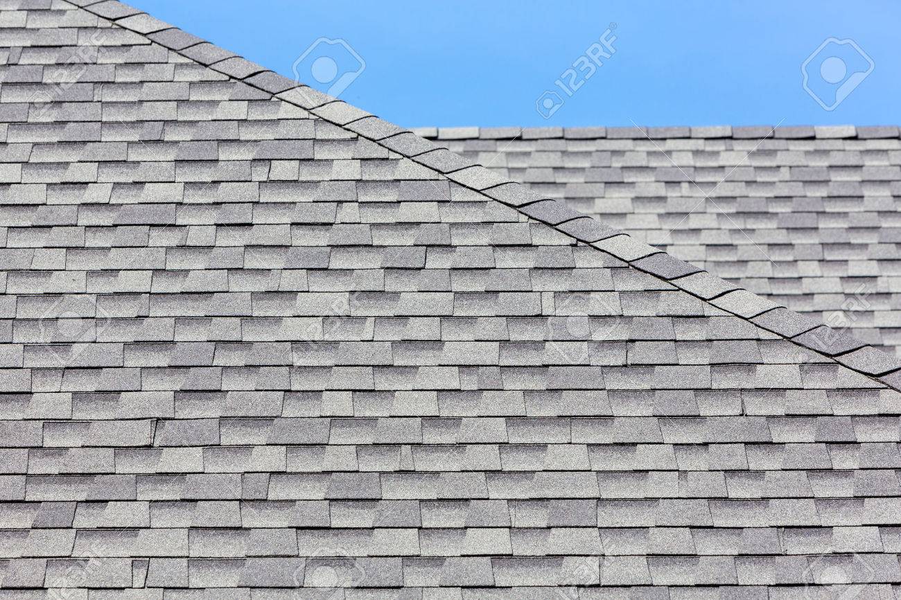 Close Up Of New Rubber Roof Tiles With Blue Skybackground Stock Photo