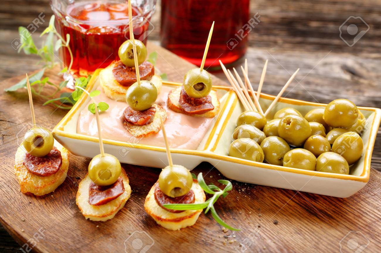 baked potatoes spanish snack with sausage chorizo and green olive