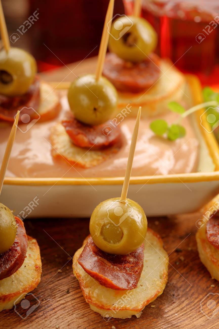baked potatoes spanish snack with sausage chorizo and green olive