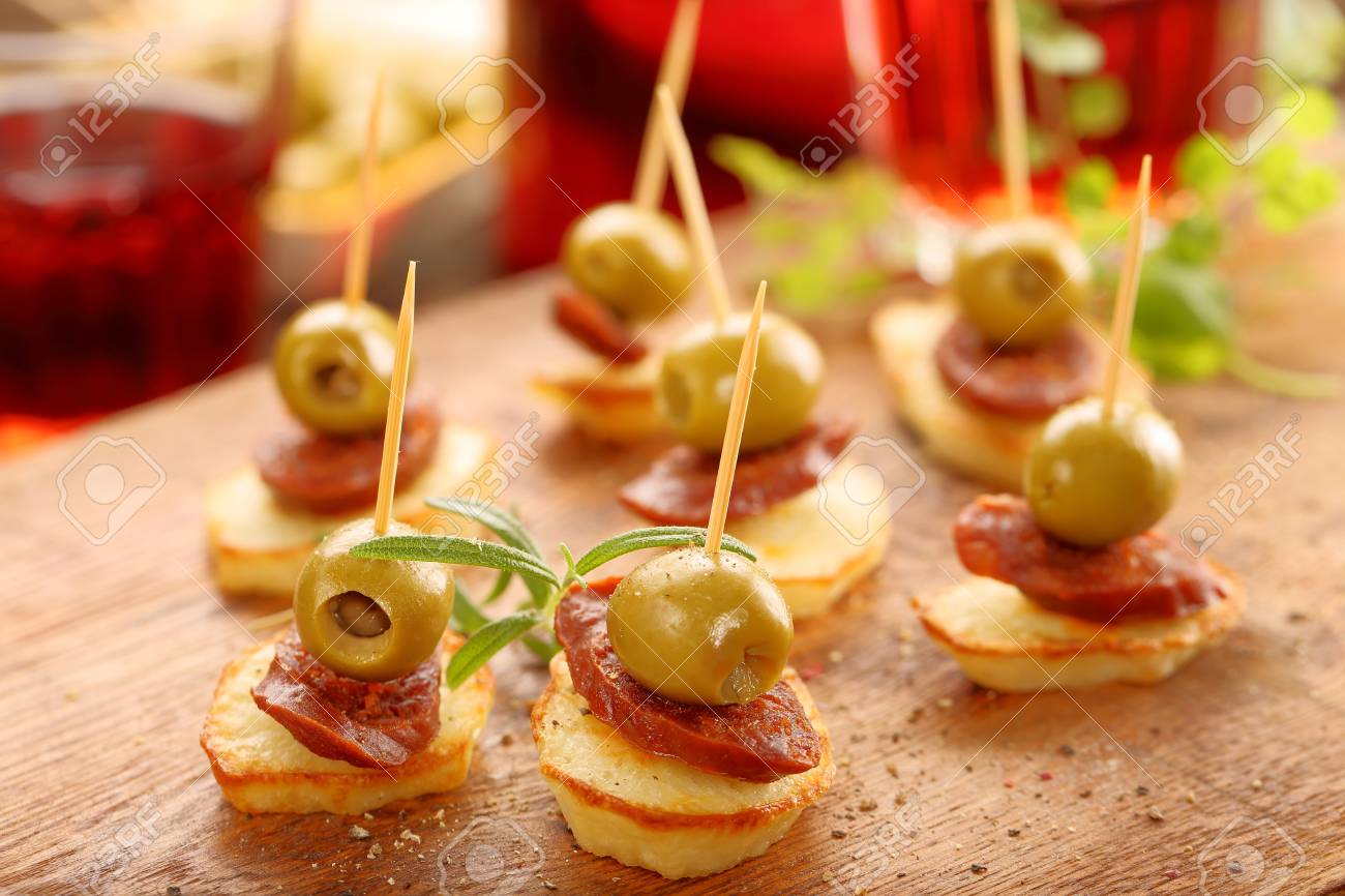 baked potatoes spanish snack with sausage chorizo and green olive