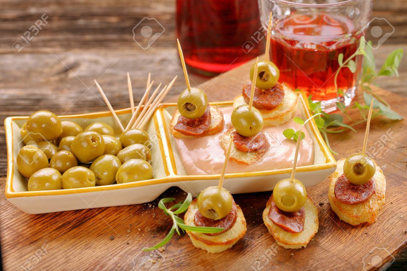 baked potatoes spanish snack with sausage chorizo and green olive