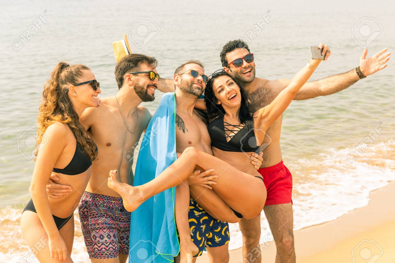 Happy Friends Taking A Selfie On The Beach In Barcelona Multiracial