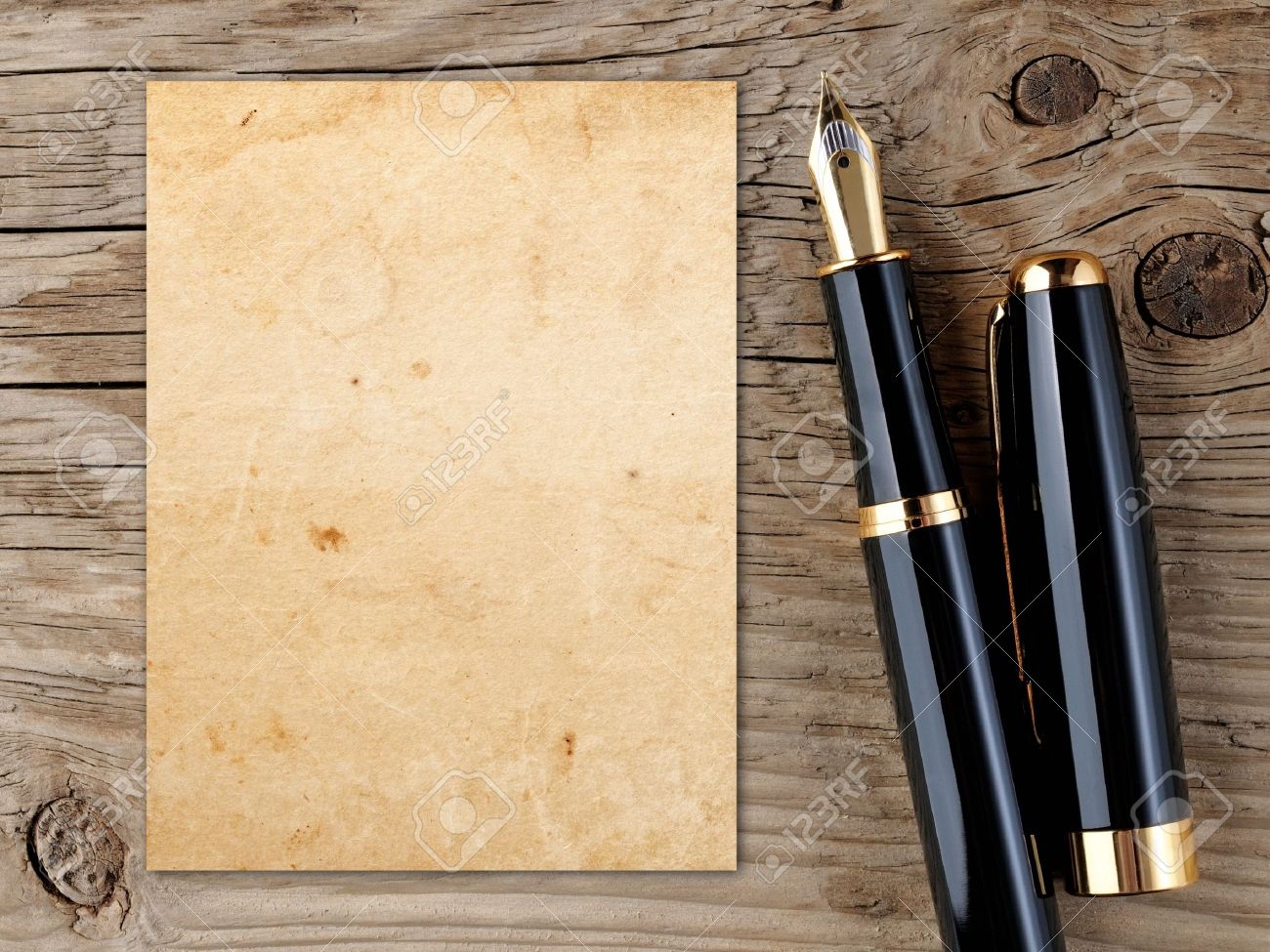 Fountain pen and vintage paper on old wooden background - 17442327 Fountain pen and vintage paper on old wooden background - 17442327