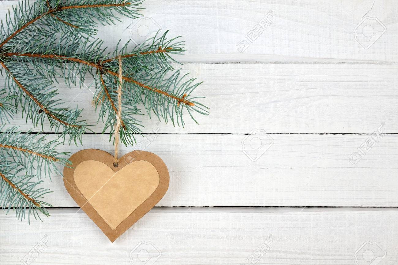 Paper heart and branches of blue spruce on wooden background - 23860272 Paper heart and branches of blue spruce on wooden background - 23860272