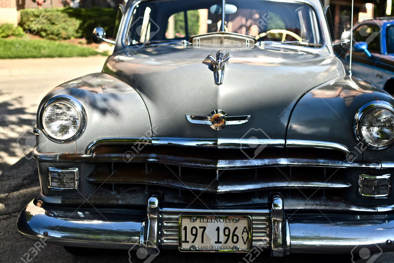DOWNERS GROVE, UNITED STATES - Jun 07, 2019: A closeup shot of an old retro car in the parking lot in Downers Grove, United States - 157222745 DOWNERS GROVE, UNITED STATES - Jun 07, 2019: A closeup shot of an old retro car in the parking lot in Downers Grove, United States - 157222745