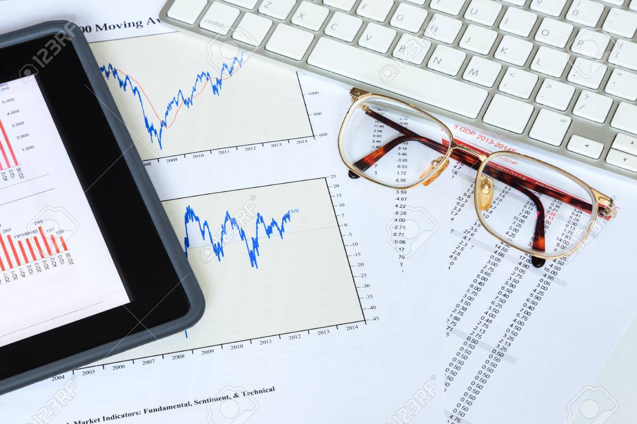 tablet computer and financial charts for stock investment analysis stock investment analysis