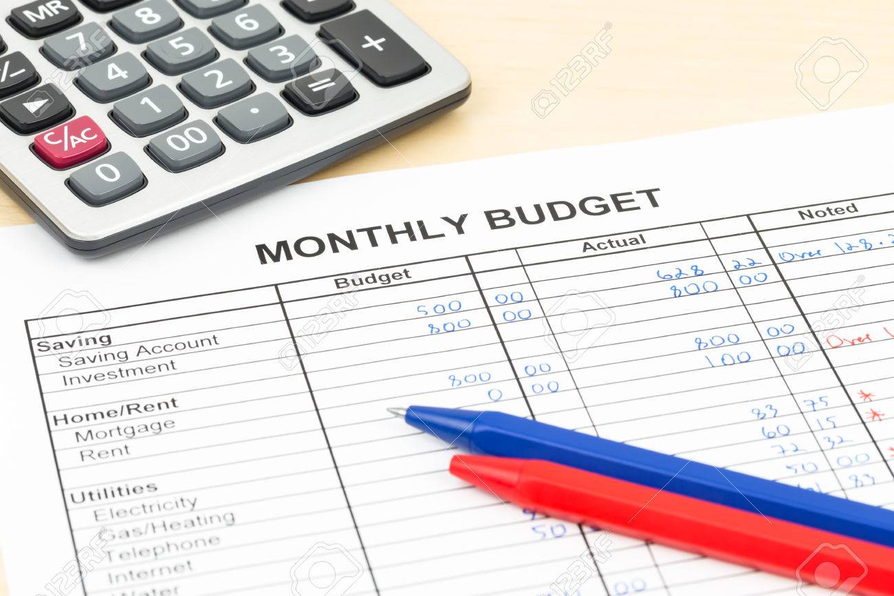 home budget planning sheet with pen and calculator stock photo