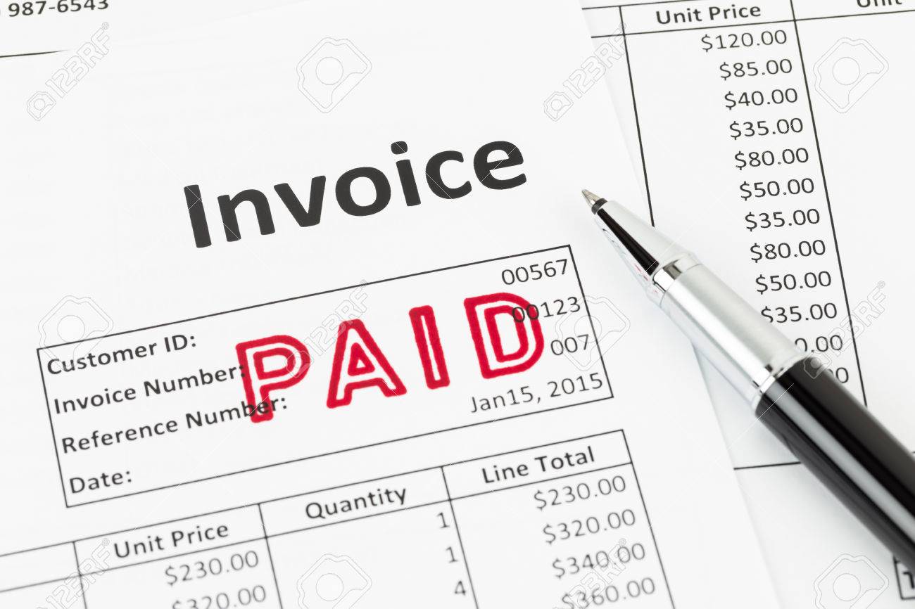 invoice and pen with paid stamp invoice is mock up stock photo