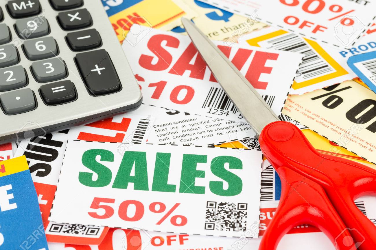 saving discount coupon voucher with scissor and calculator coupons