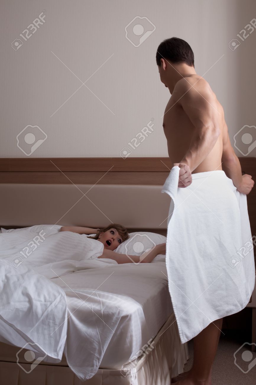 Shocked Woman Looking At Nude Man In Bedroom Stock Photo, Picture And Royalty Free Image