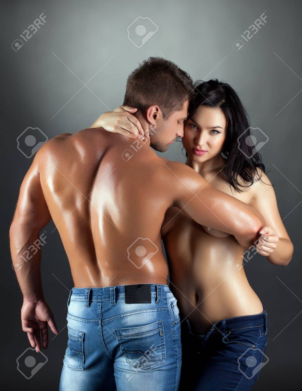 Close-up of sweaty, intimate couple bodies in passionate embrace