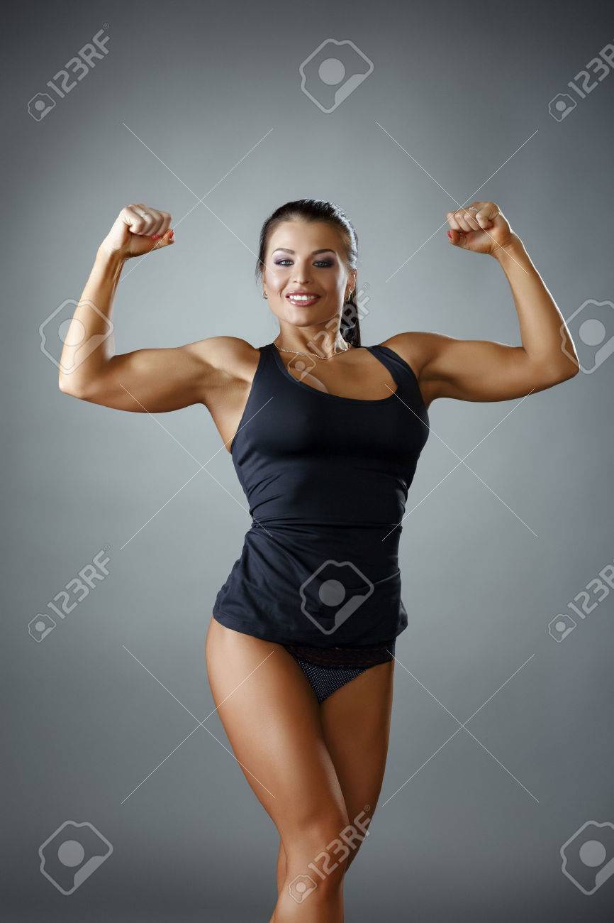 Happy Female Bodybuilder Showing Her Biceps At Camera Stock Photo, Picture  and Royalty Free Image. Image 46563014.