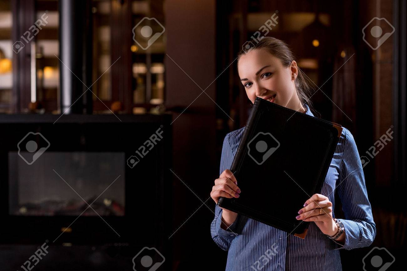 Image of smiling waitress hiding her face behind menu - 49592682 Image of smiling waitress hiding her face behind menu - 49592682