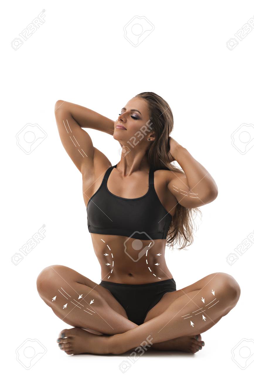 Muscular female bodybuilder sitting in yoga pose Muscular female bodybuilder sitting in yoga pose