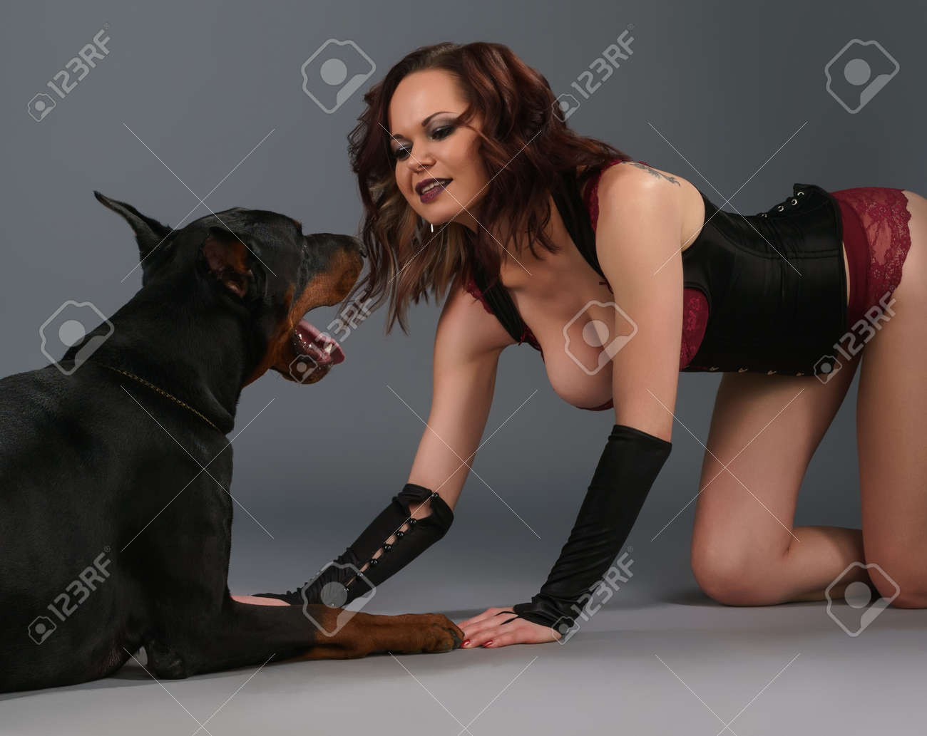 Sexy Girl On Her Knees Looking At Dog Lying Near Stock Photo, Picture and  Royalty Free Image. Image 169521090.