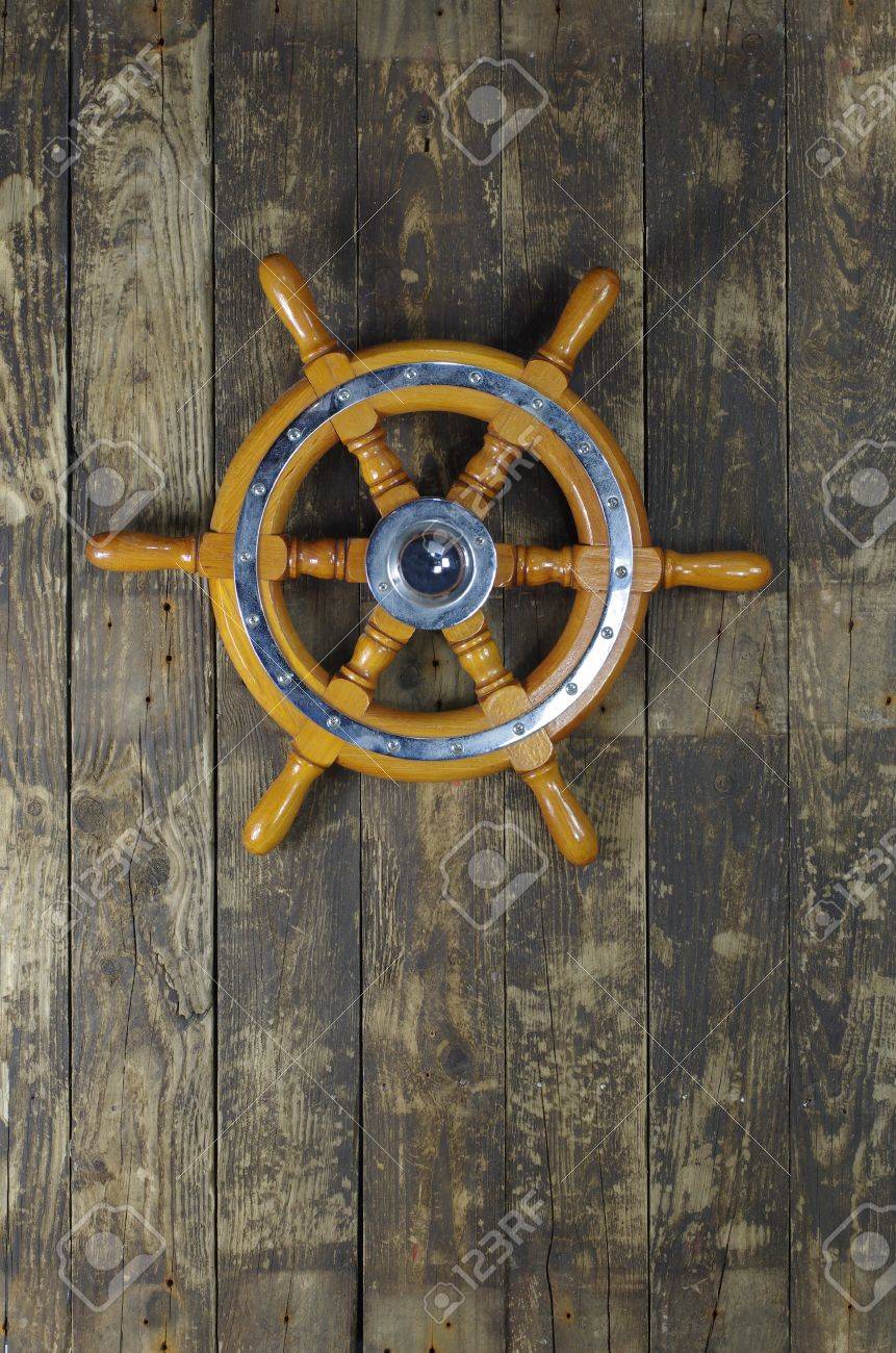 steering wheel of sailing-ship on a board background - 16025920 steering wheel of sailing-ship on a board background - 16025920