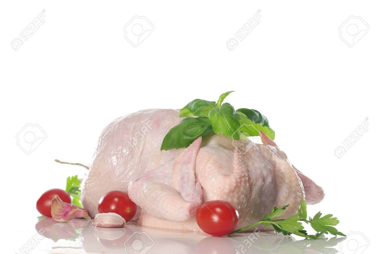 raw chicken with parsley on black plate - 143402460 raw chicken with parsley on black plate - 143402460