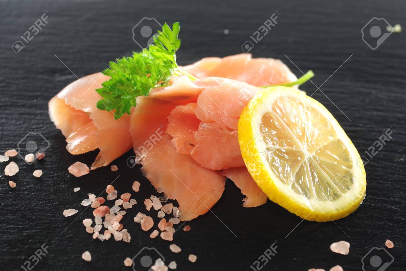 slices of smoked salmon with dill black plate background - 142680773 slices of smoked salmon with dill black plate background - 142680773