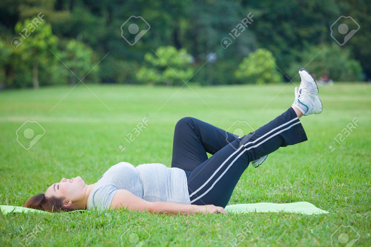 Asian fat woman lying by exercise leg upwards at the park - 40080913 Asian fat woman lying by exercise leg upwards at the park - 40080913