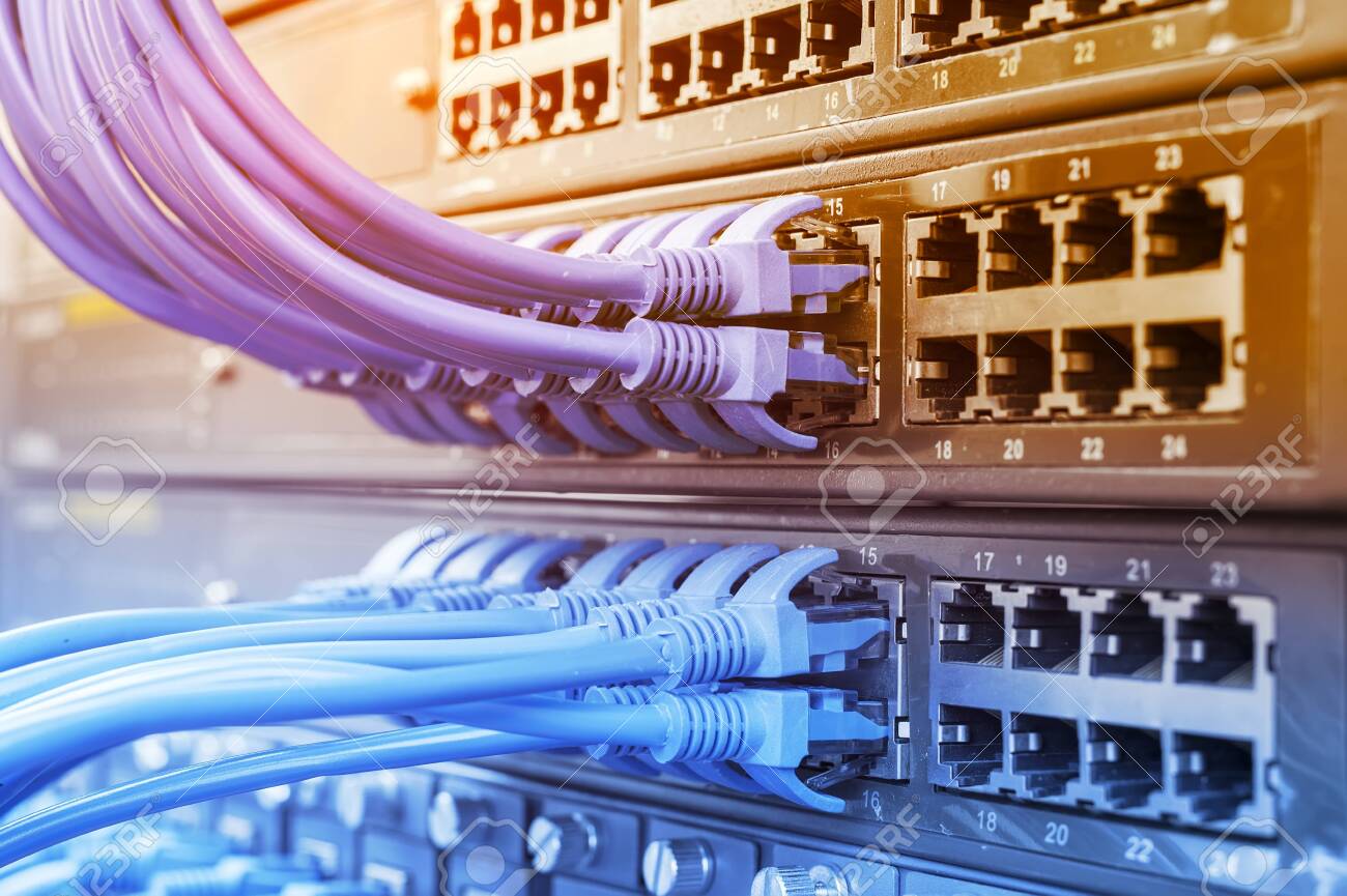 Server rack with blue and red internet patch cord cables connected to black patch panel in data server room - 137128730 Server rack with blue and red internet patch cord cables connected to black patch panel in data server room - 137128730