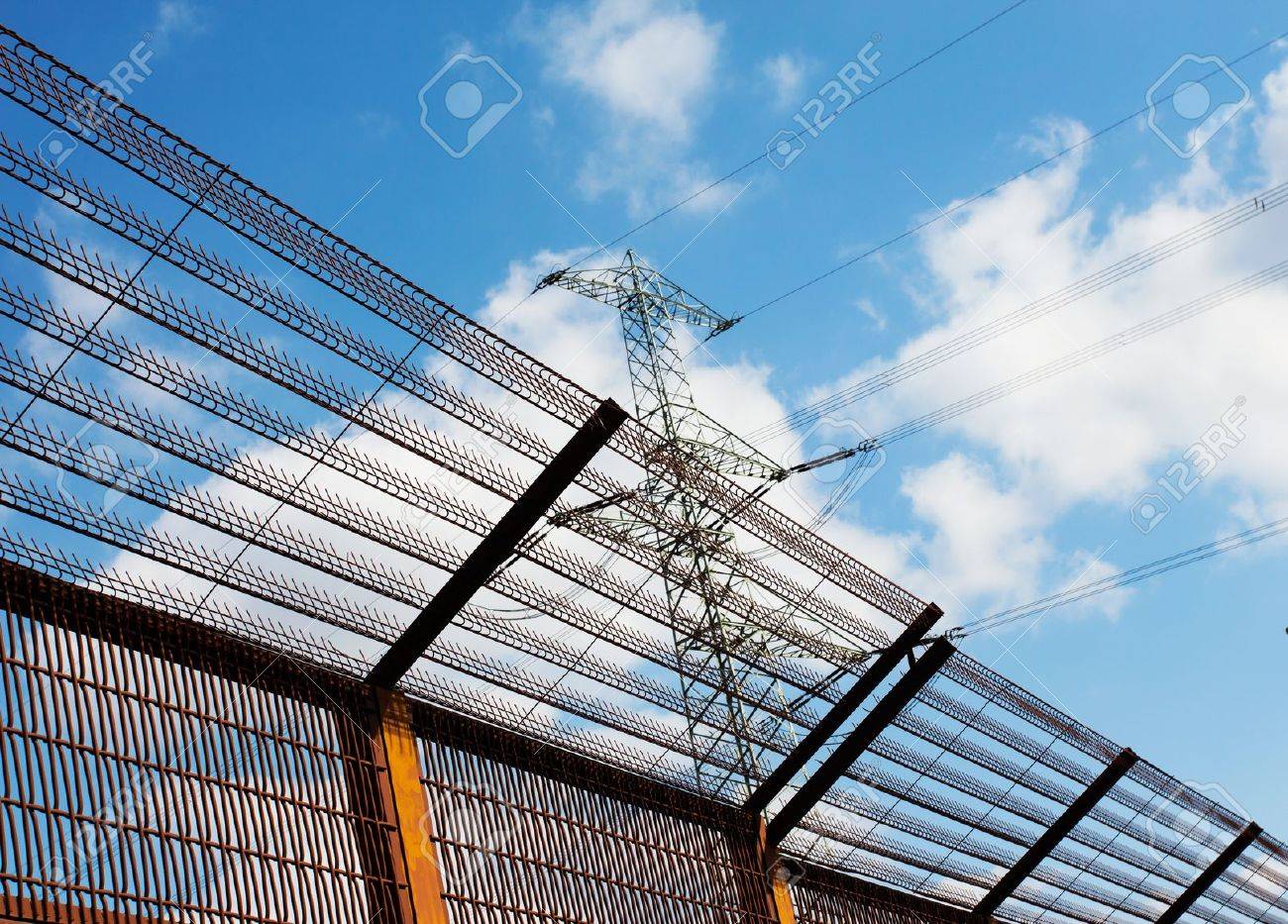 Barrier fence and Electricity pylon against the blue sky - 21359904 Barrier fence and Electricity pylon against the blue sky - 21359904