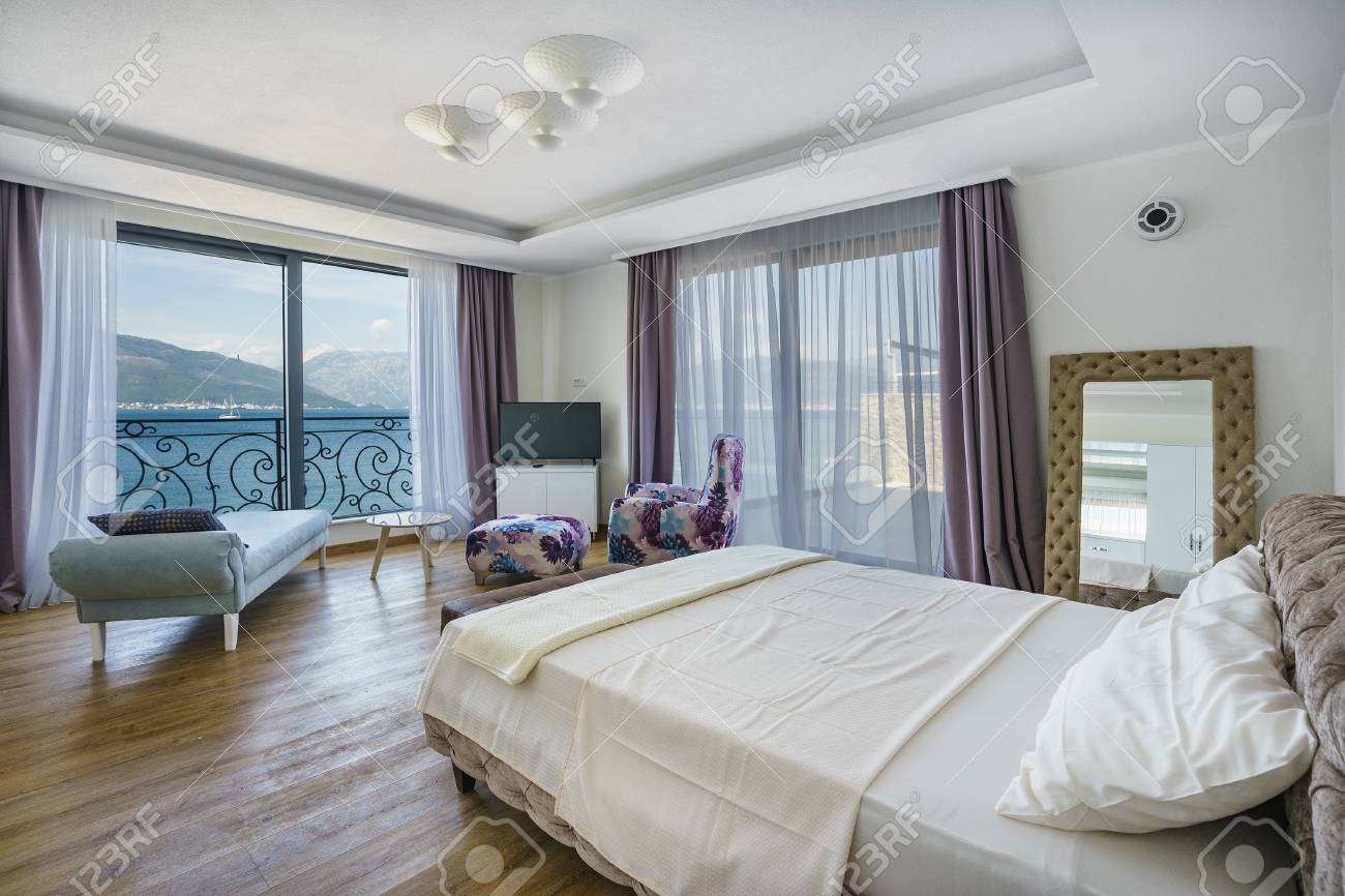 Interior Of A Spacious Light Bedroom With Sea View In A Luxury