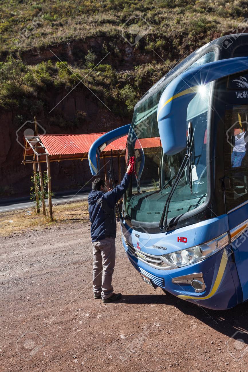 cusco peru may 15 professional bus driver cleaning the professional bus driver