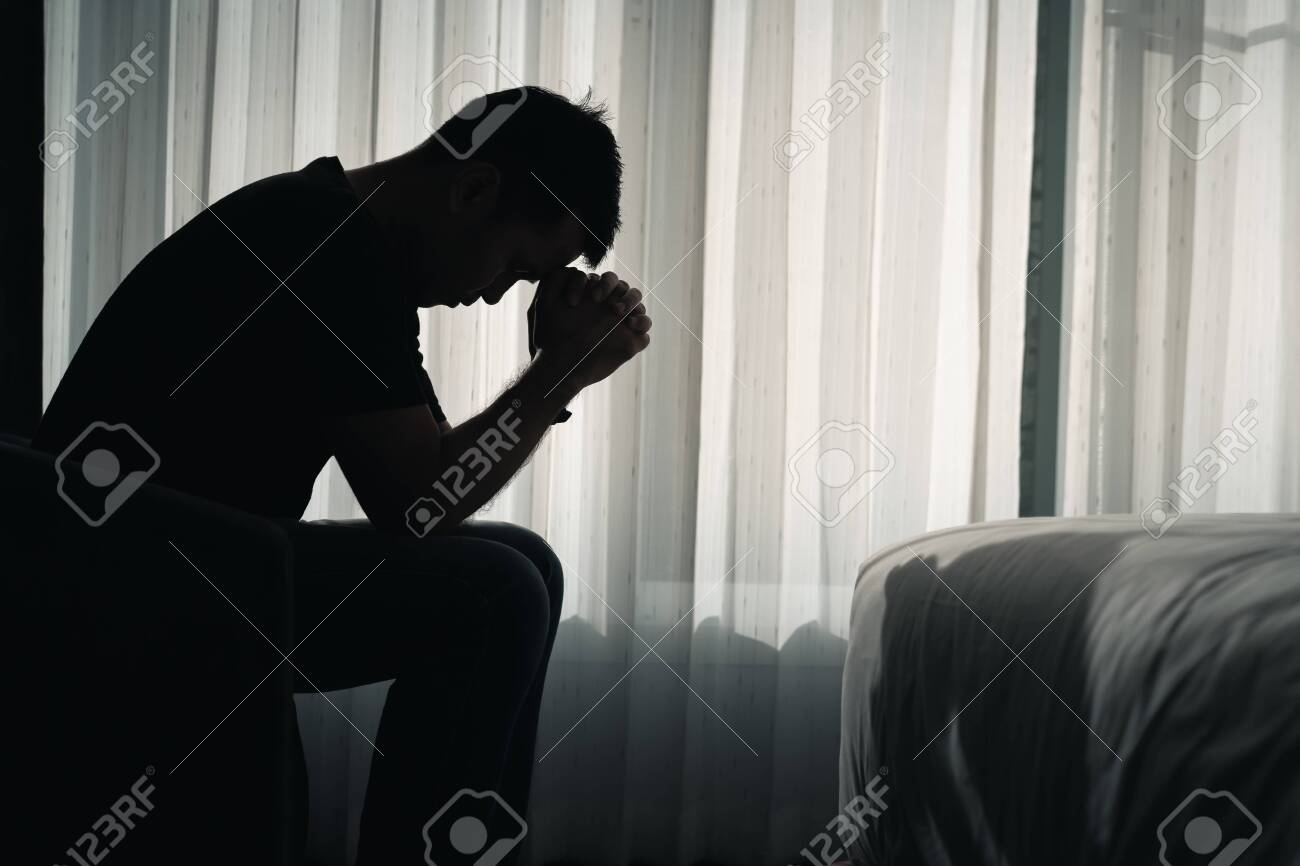 Silhouette depressed man sadly sitting on the bed in the bedroom, depression concept - 159061848 Silhouette depressed man sadly sitting on the bed in the bedroom, depression concept - 159061848