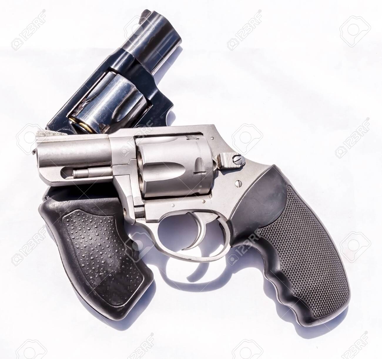 Two Handguns A Stainless Steel 357 And A Black 38 Special Revolver Stock Photo Picture And Royalty Free Image Image