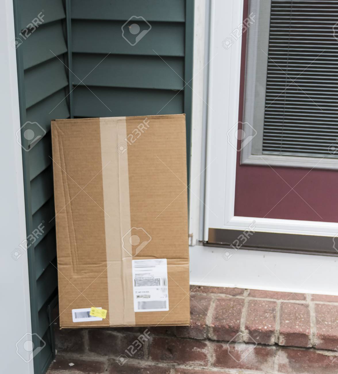 a package is left at the side door of a residential home after being