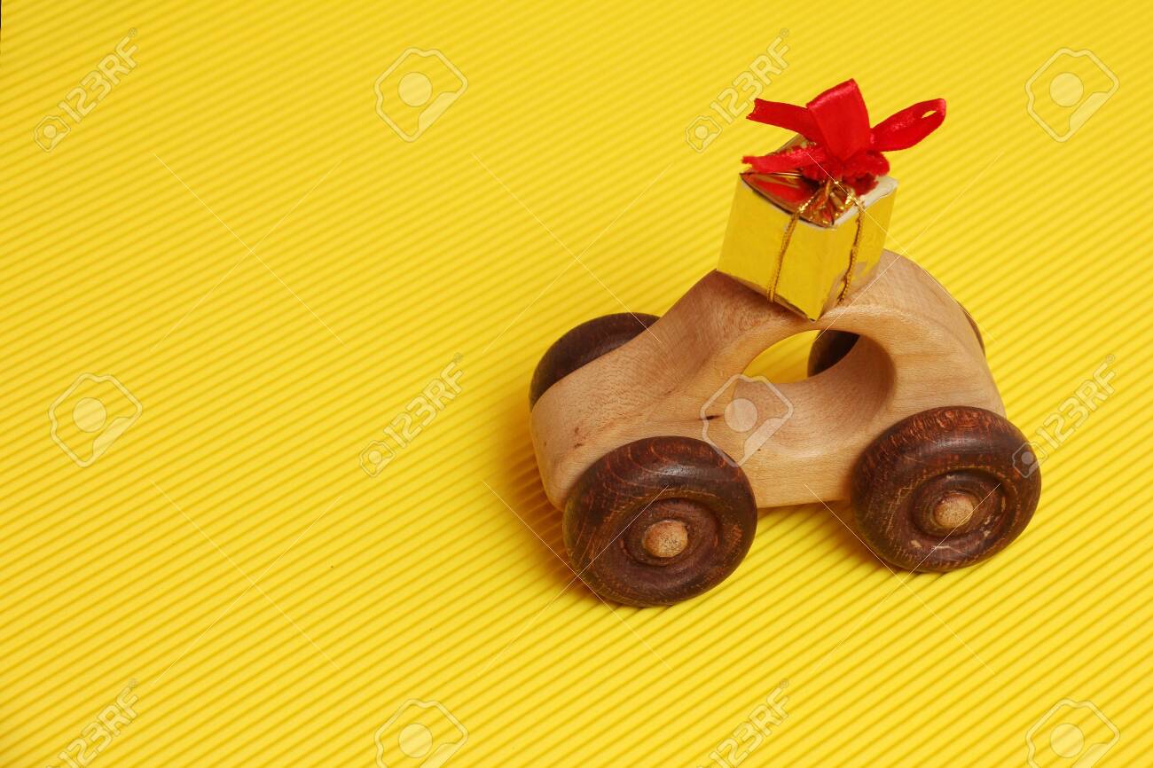 red toy car with yellow roof