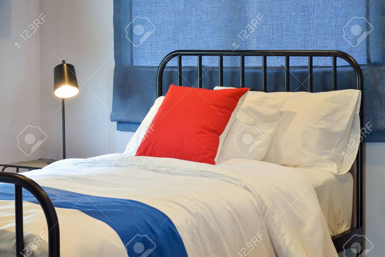 Modern Bedroom Interior With Pillows And Blue Roman Blind