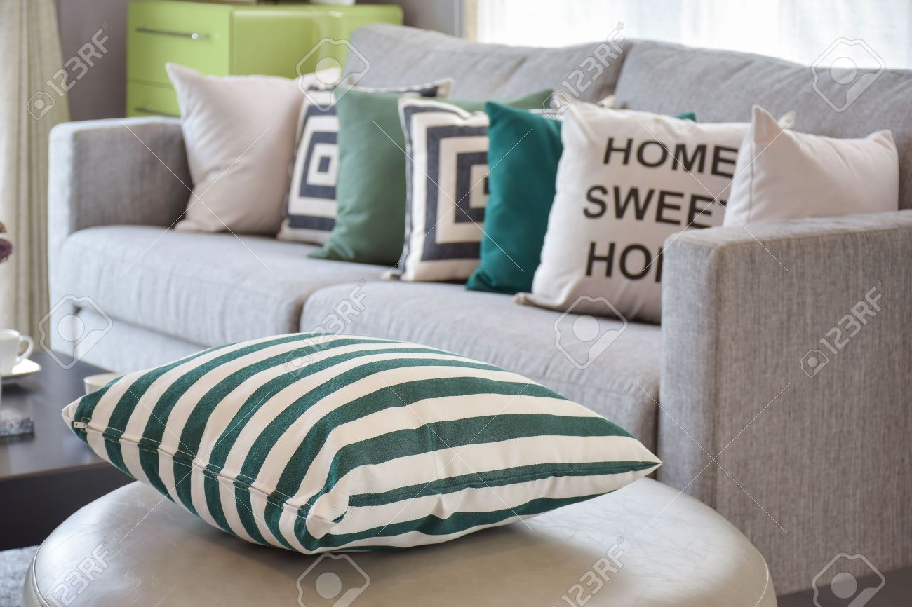 green striped pillows on the cozy grey sofa in the living room green striped pillows on the cozy grey sofa in the living room