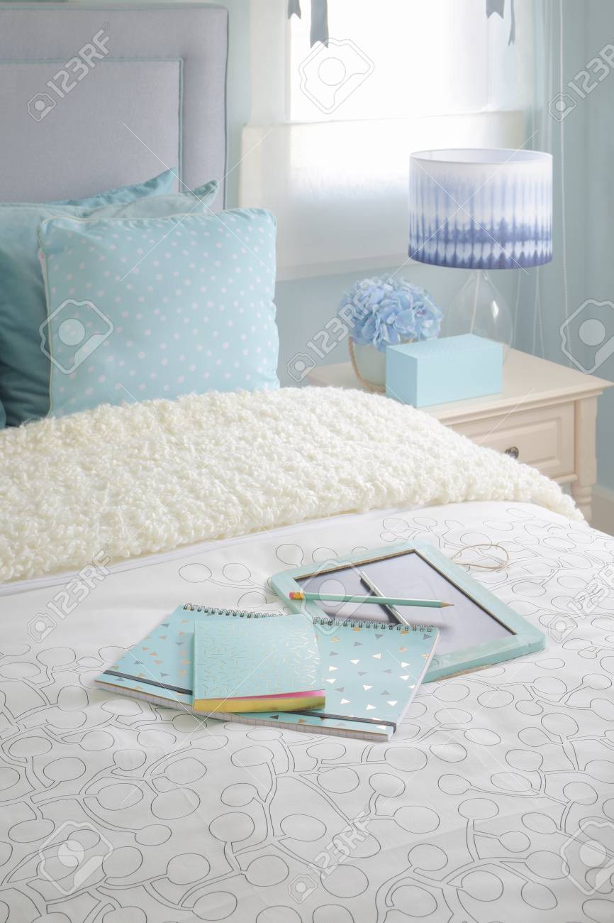 Blue Color Notebook On Bed In Light Blue Color Scheme Bedroom