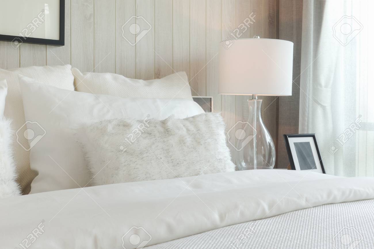 Luxury Style Bedding With Puffy Pillow And White Table Lamp In
