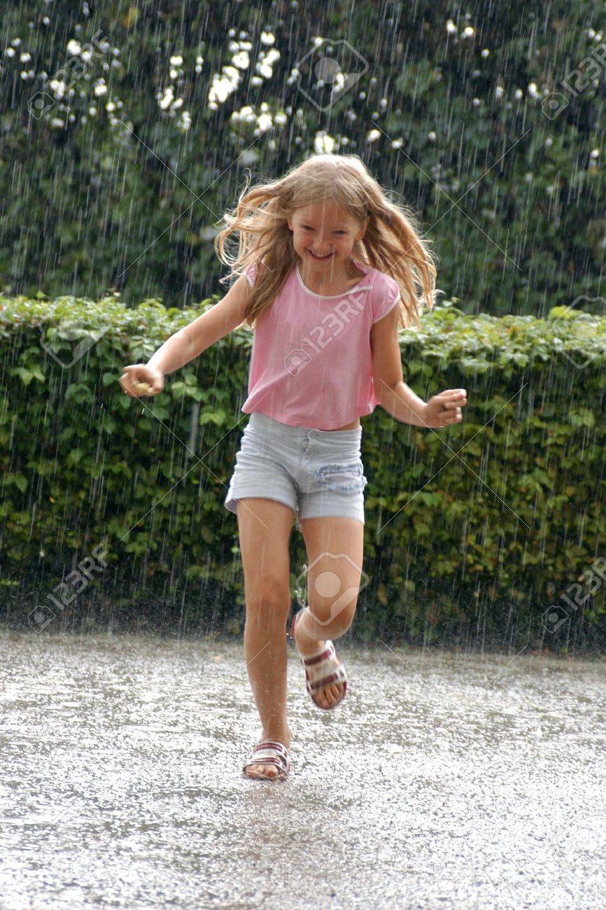 Young Girl Running In The Heavy Rain In The Park Stock Photo, Picture And  Royalty Free Image. Image 15635473.