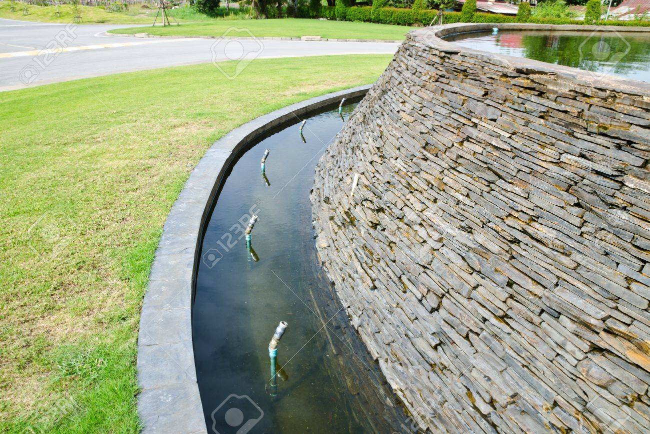 decorative fountain wall with a slate stone in the garden stock decorative fountain wall with a slate stone in the garden stock