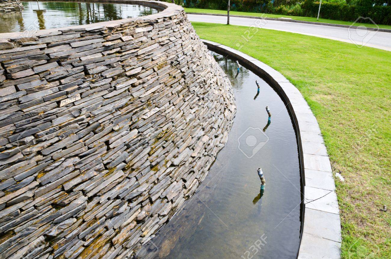 decorative fountain wall with a slate stone in the garden stock decorative fountain wall with a slate stone in the garden stock