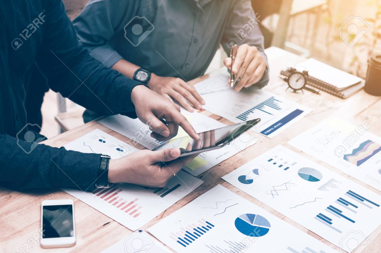 two entrepreneur person working and colleague analyzing data stock analyzing data