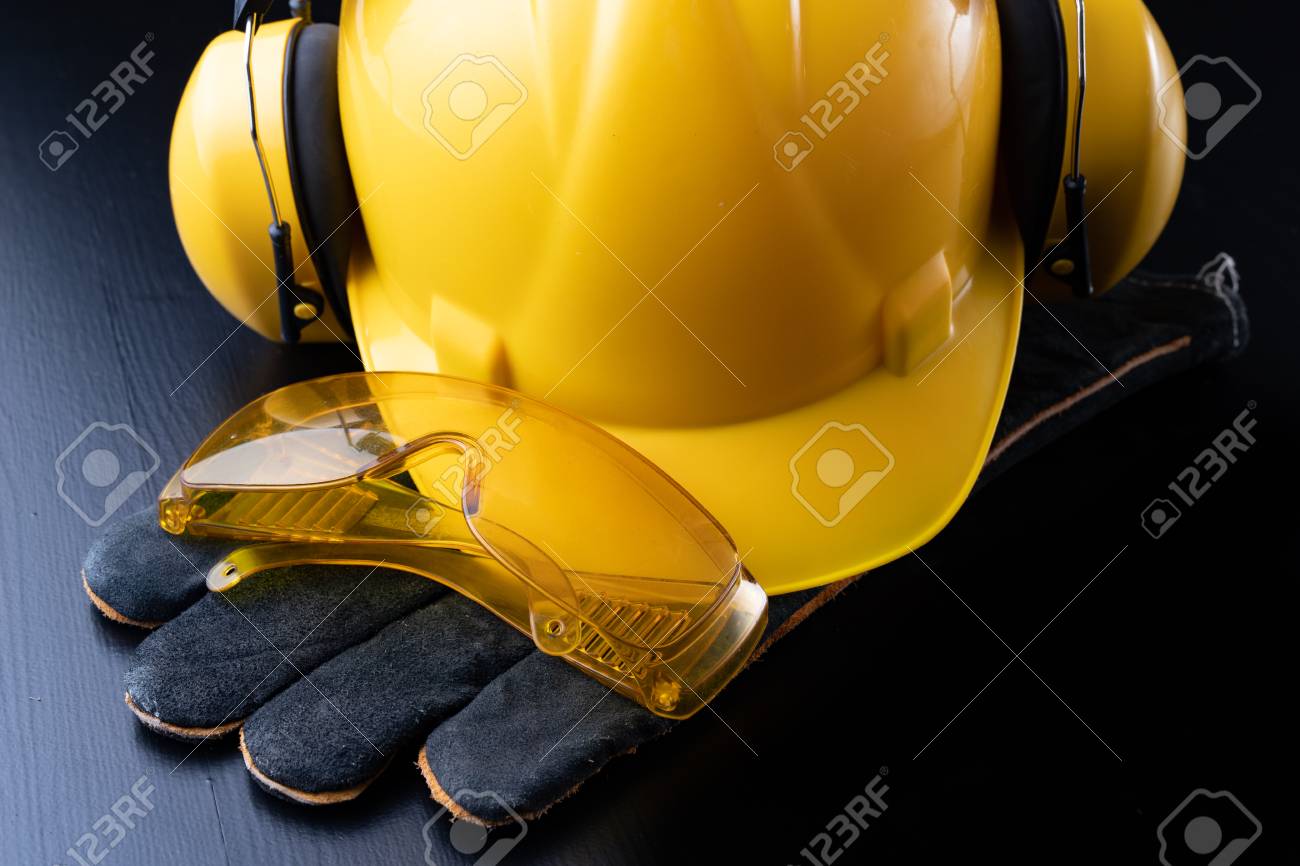 Helmet and accessories for construction workers. Accessories needed for work on the construction site. Dark background. - 116559840 Helmet and accessories for construction workers. Accessories needed for work on the construction site. Dark background. - 116559840